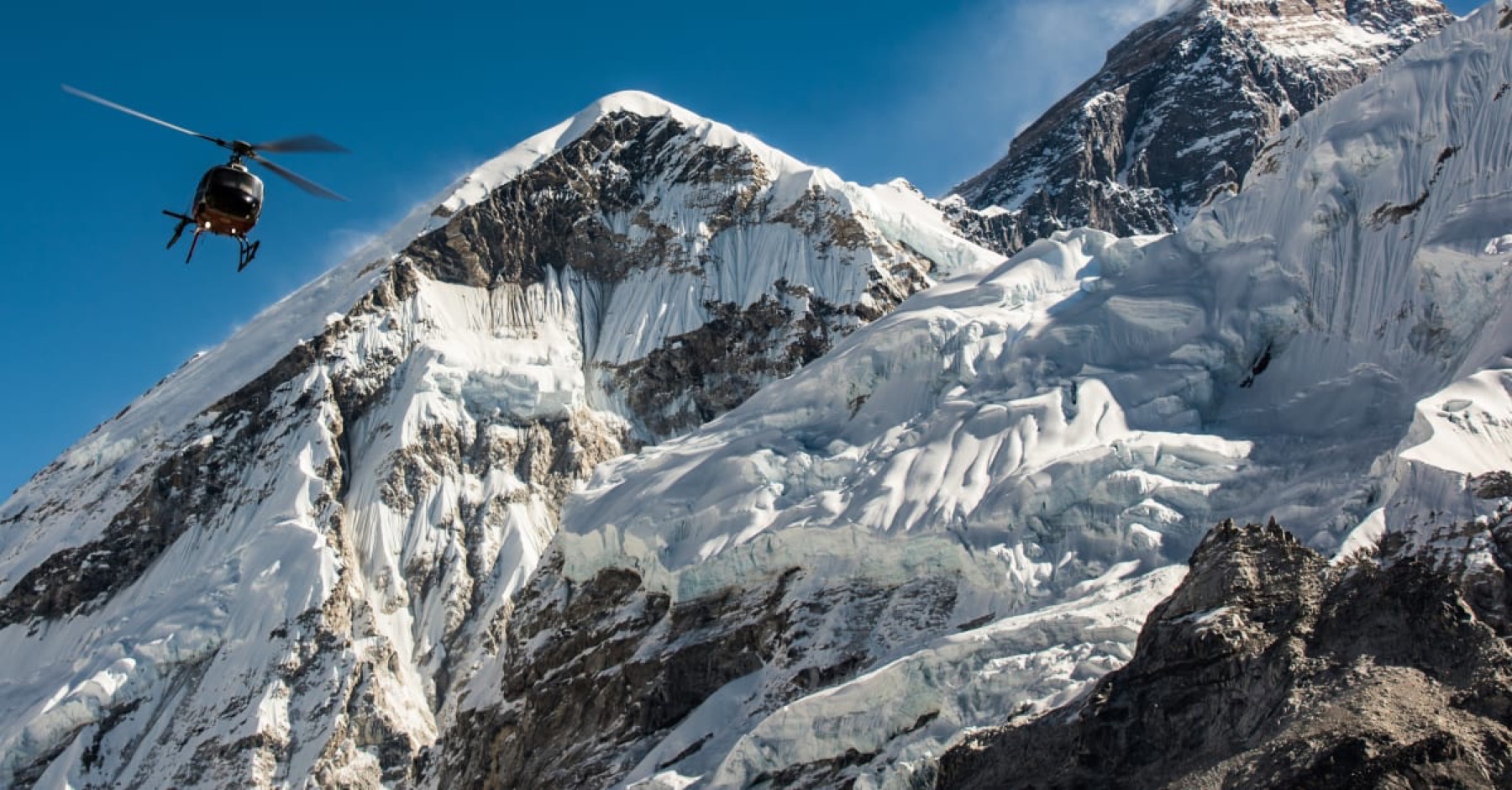 A helicopter beneath the summit of Everest